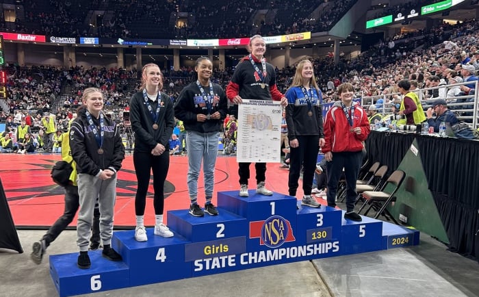 Westside's Regan Rosseter stands atop the podium as a three-time Nebraska state wrestling champion. She is technically a four-time champion counting a win in the NSWCA tournament as a freshman. Photo from @WHSGirlsWrestle on X.